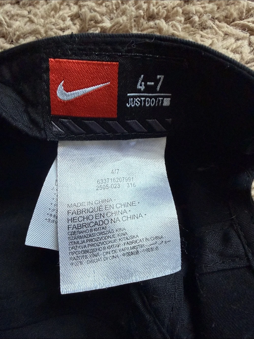 Nike Black Baseball Cap with White Swoosh and Red Accents for boys